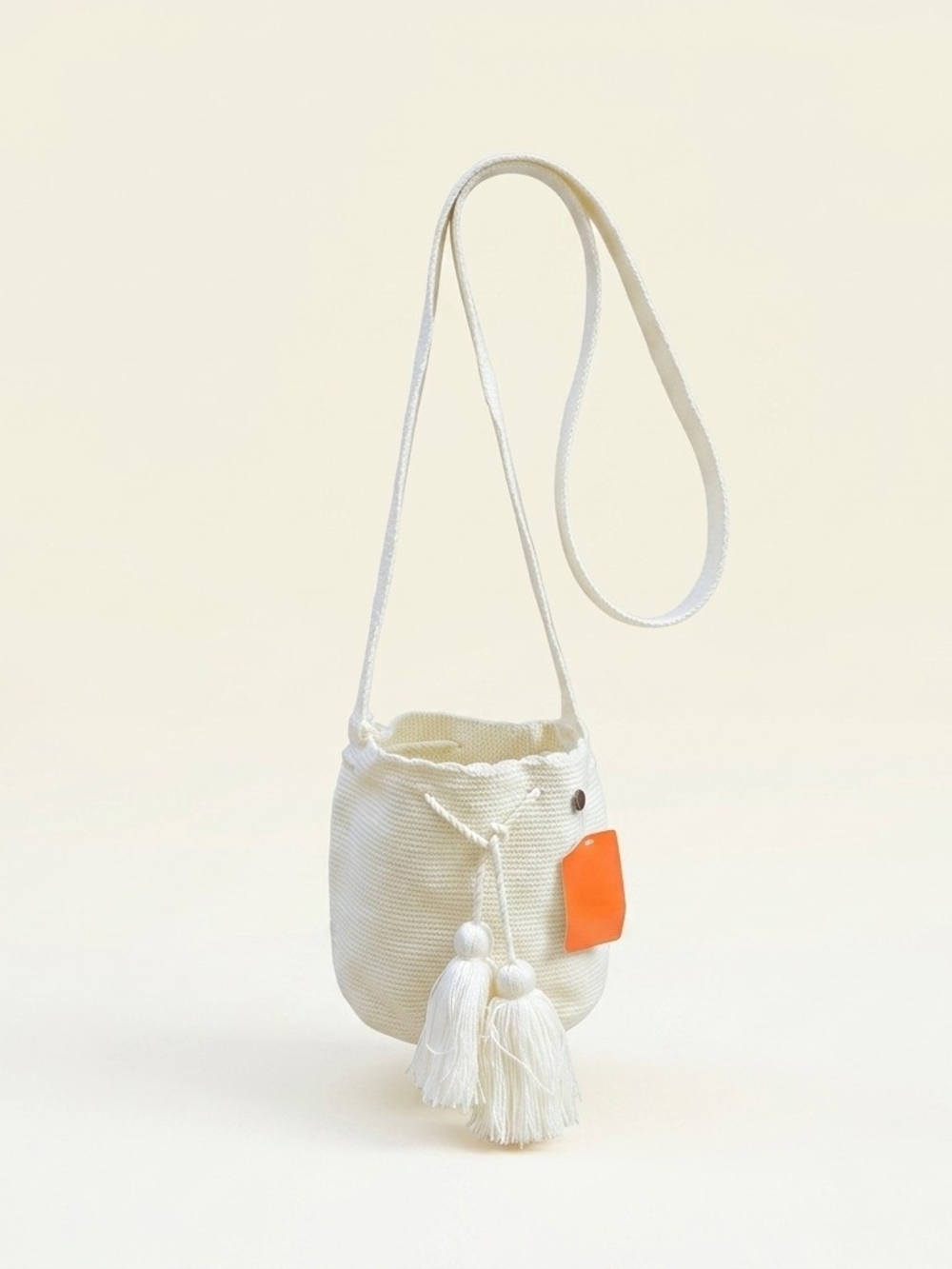 Cream Woven Bucket Crossbody Bag with Tassels and Orange Tag